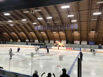 Indoor ice rink showing hockey players